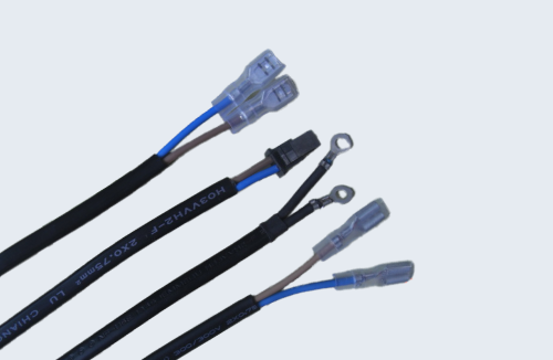 Close-up view of a custom black electrical wire harness assembly.